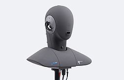 Artificial head HMS II.3 ViBRIDGE wearing earplugs for testing.